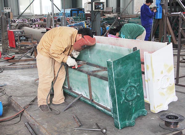 Steel welding work during production of 24 seat pirate ship amusement park ride