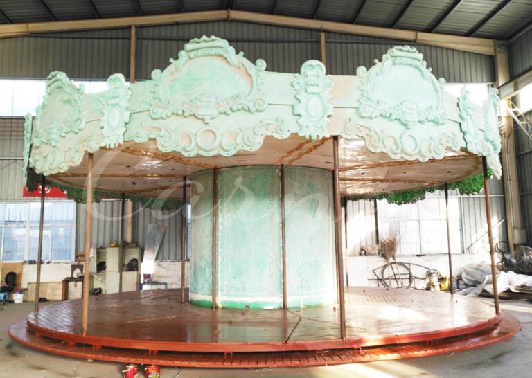 Unpainted fiberglass and steel structure of carousel under workshop assembly stage