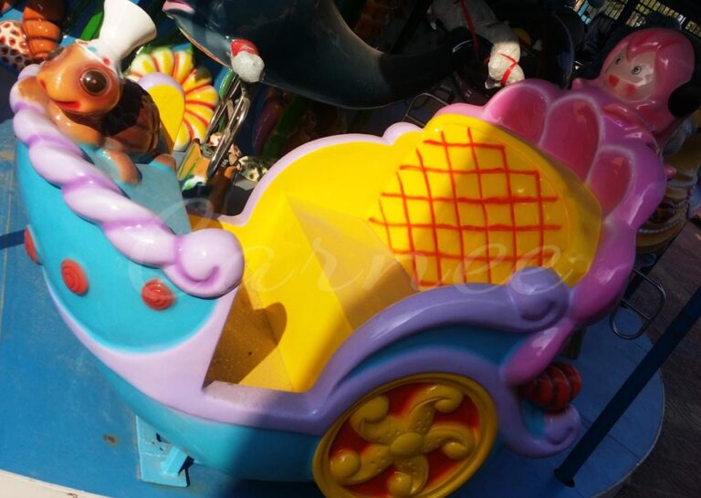 Shell-shaped carriage seat on the carousel, decorated with playful turtles and dolphins for younger kids.