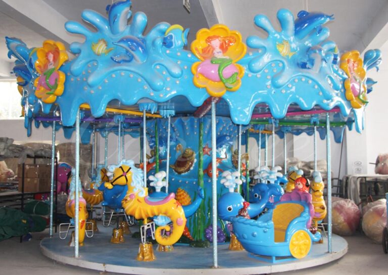 Ocean-themed carousel ride installed in a theme park with colorful fish and seahorse seats