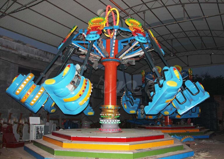 Airborne Shot ride illuminated at night with colorful lights, creating an exciting and thrilling ambiance.