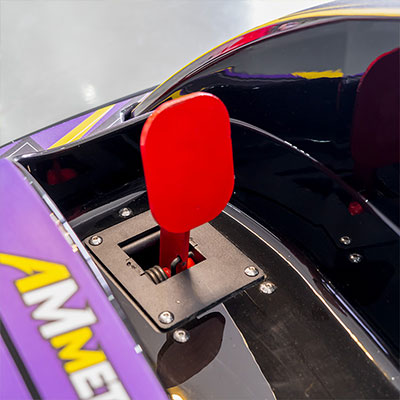 Close-up of the reverse pedal on the Anmi Kids Go-Kart, featuring a red color for easy identification and safe operation