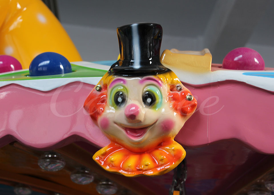 Close-up of clown face decoration on the clown flying chair ride carousel top
