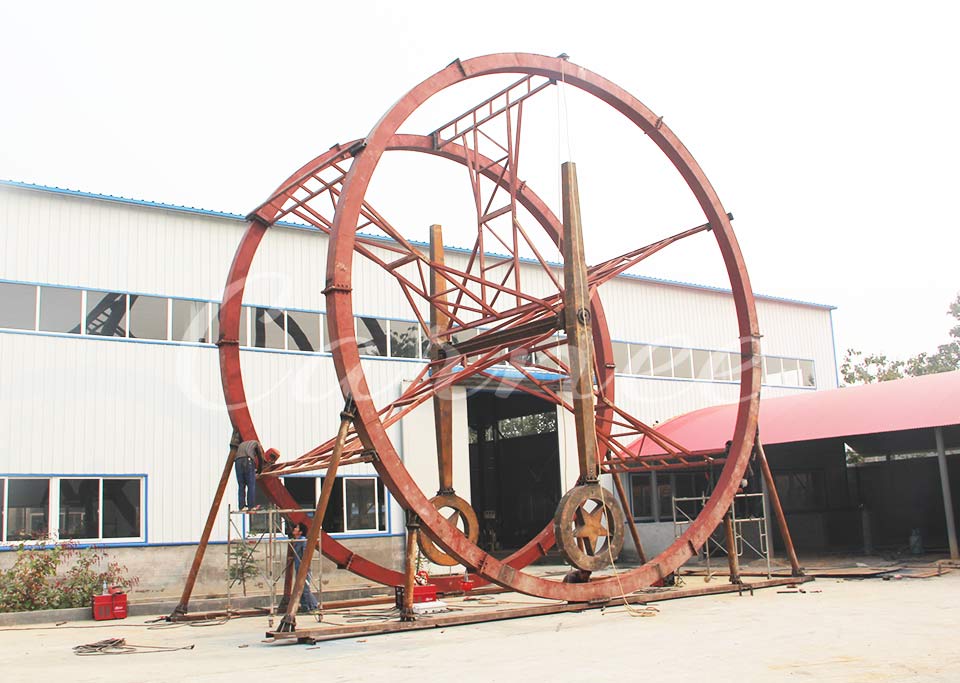In-progress construction of Ferris Ring Ride metal frame at Carnee Rides factory
