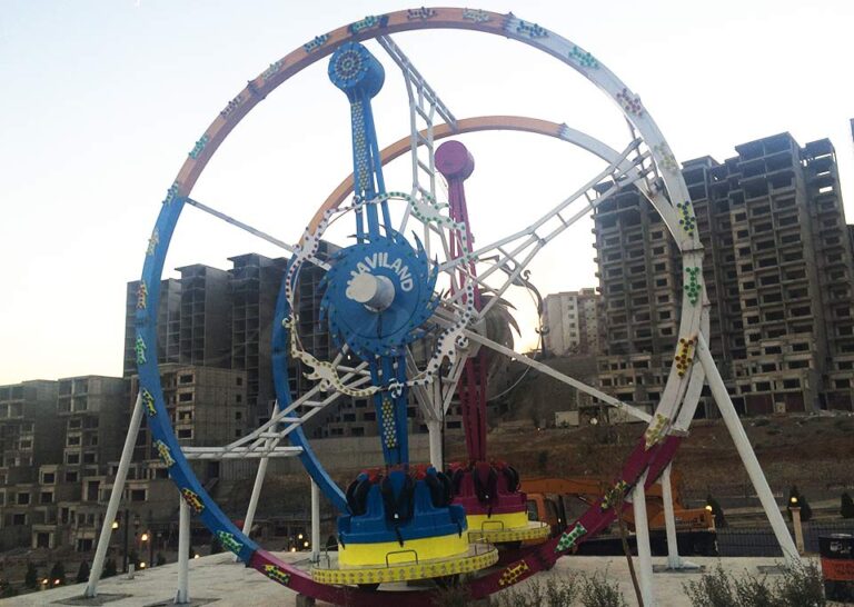 Ferris Ring Car installed in urban area, photographed during twilight showing dramatic silhouette