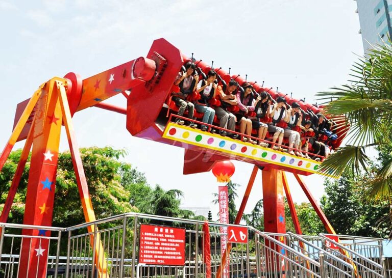 Top Spin ride under installation with full ride cabin lifted by crane on site