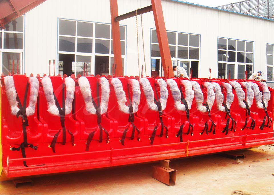 Top Spin ride seat row in red, fully equipped with shoulder harnesses for secure ride