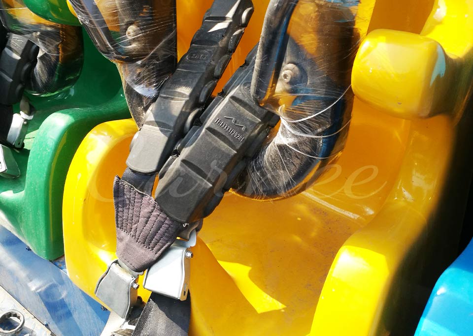 Close-up view of ergonomic safety harness and shoulder restraints on Top Spin seat