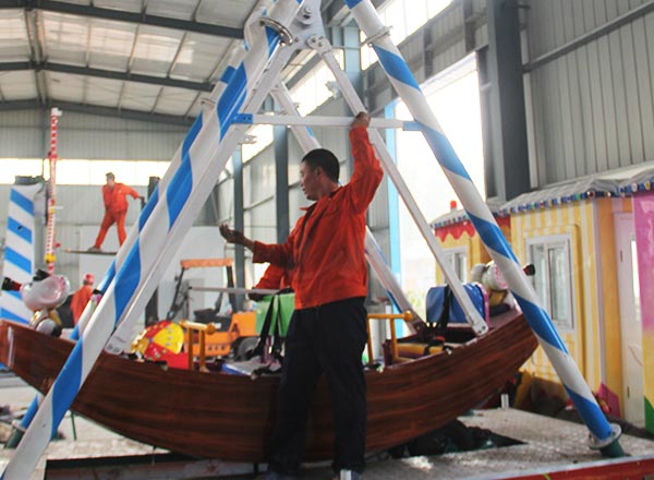 Assembly of 12 seat mini pirate ship amusement ride inside amusement equipment factory