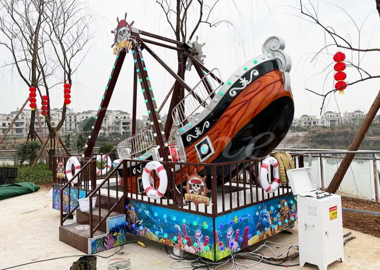 Mini Pirate Ship Ride with LED lights and pirate design at amusement park