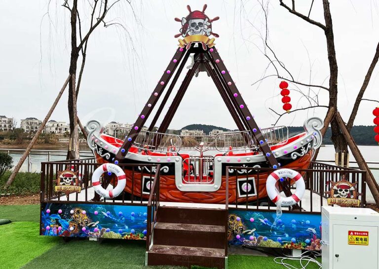 Front view of Mini Pirate Ship Ride with safety features and vibrant decorations