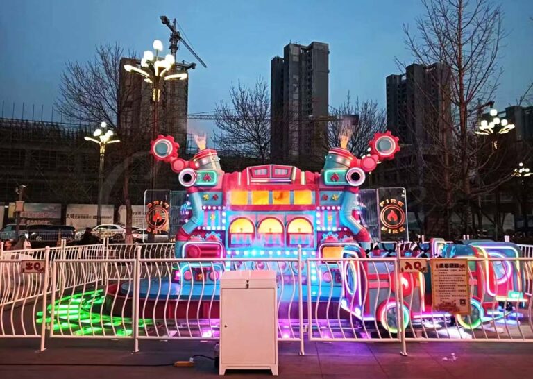 Bright and colorful Urban Firefighting Heroes Track Train Ride illuminated in daylight with steam effects.