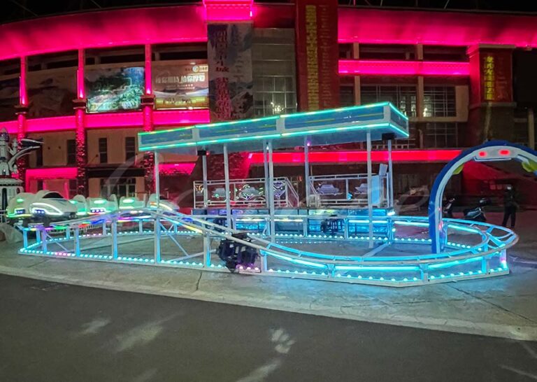 High-speed train roller coaster installed in a shopping mall with bright lighting.