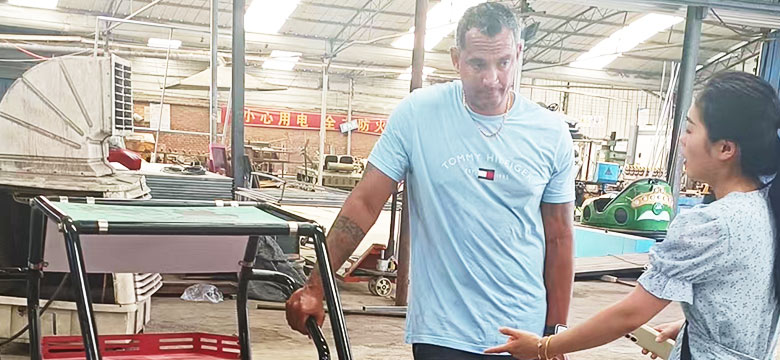 Brazilian client discussing off-road buggy ride model with Carnee Rides staff during July 2025 factory visit.