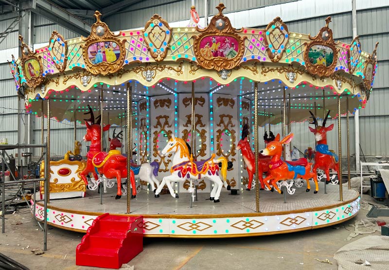 Factory photo of 24-seat carousel ride produced for Ethiopian customer by CARNEE Rides, featuring animal themed horses and deer, colorful LED lights, before delivery