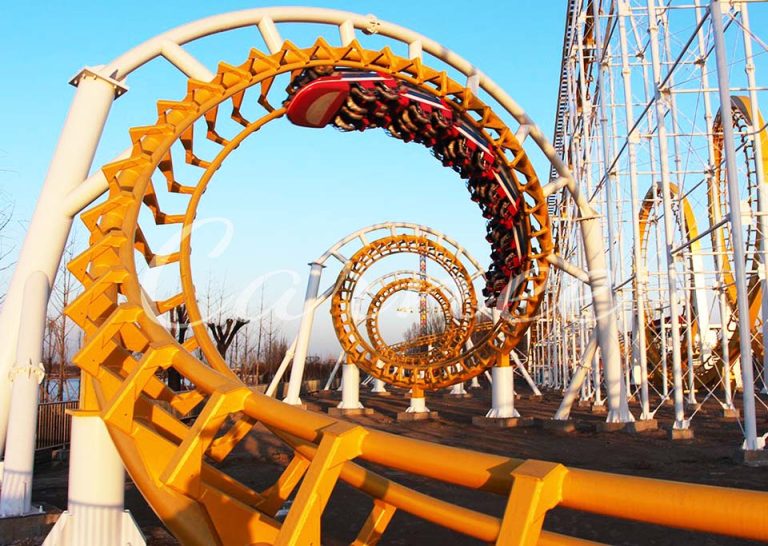 Six Loops Roller Coaster train descending from a giant vertical loop, offering extreme thrill and speed.