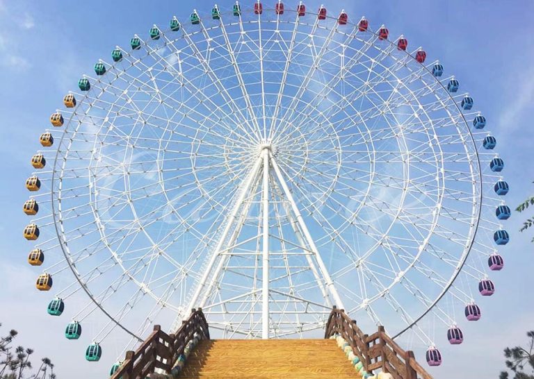 A panoramic view of the 66m Ferris wheel, showcasing the vibrant cabins and the impressive height of the ride against a blue sky.
