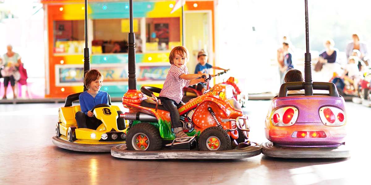 Children having fun riding bumper cars at a family-friendly amusement park.