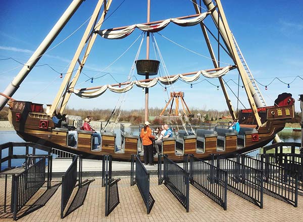 Classic Viking pirate ship amusement ride with wooden design in park