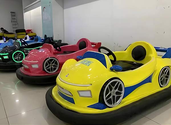 Colorful children bumper cars in yellow, red, and pink, perfect for family entertainment venues.