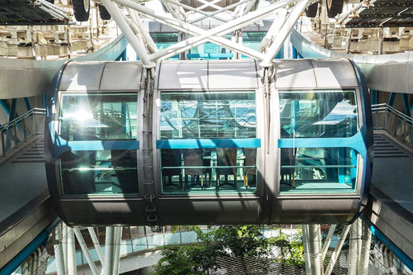 Interior view of luxury glass cabin on Ferris wheel with panoramic seating and modern design
