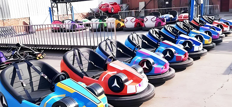 Outdoor electric bumper cars lined up at an amusement park, featuring modern car-style designs.