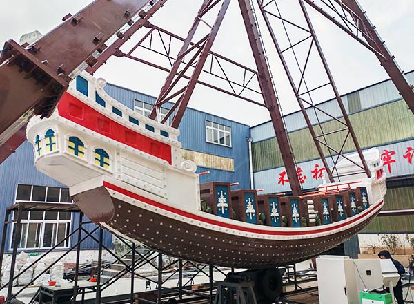 Fiberglass pirate ship ride body in factory assembly before installation.
