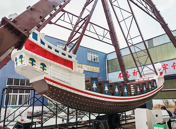 Fiberglass pirate ship ride body in factory assembly before installation.