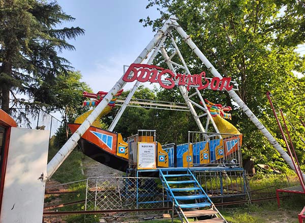 Small pirate ship ride set up in outdoor amusement area
