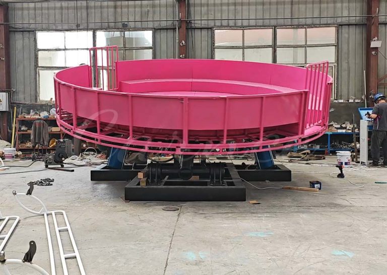Factory shot of the Tagada Ride disc base structure in pink before full assembly and decoration.