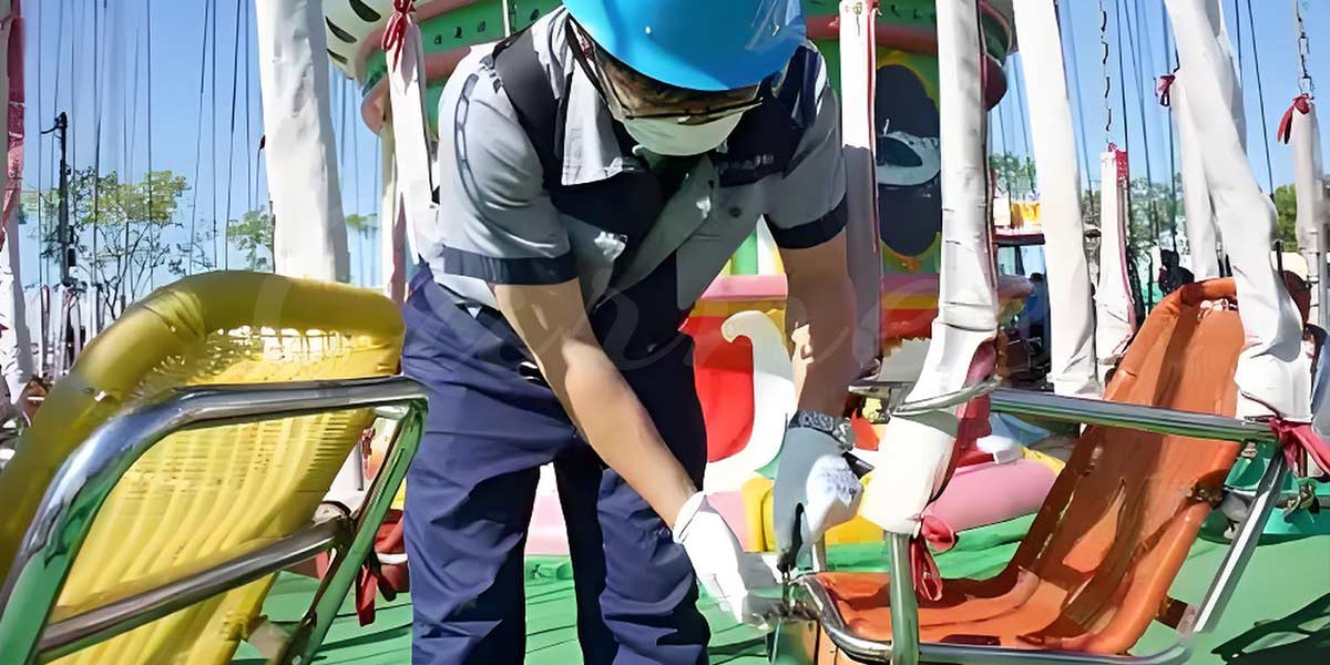 Amusement park ride safety check: maintenance worker ensuring the security of seats and safety restraints for passengers before operation.