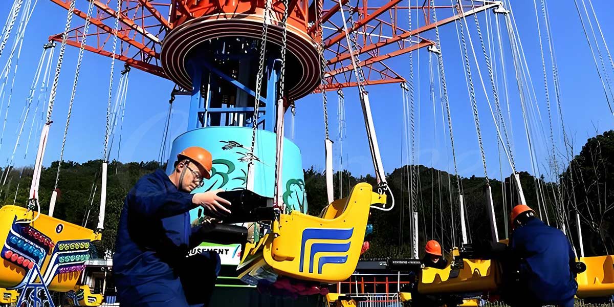 Swing Amusement park ride maintenance crew working on ride swing equipment.