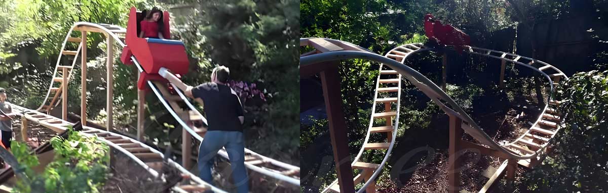 DIY backyard roller coaster with wooden track and red cart built in a garden