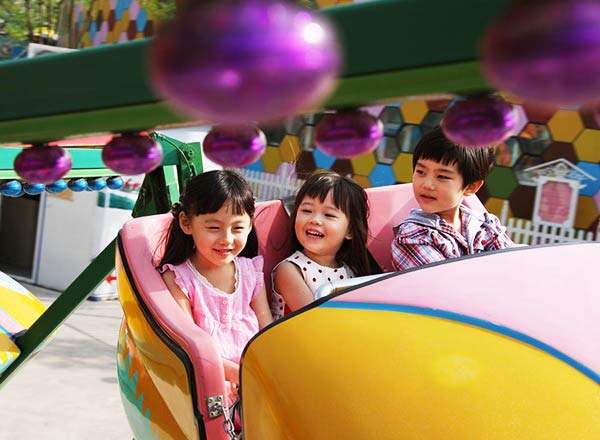 Passengers enjoying roller coaster ride with visible safety restraints