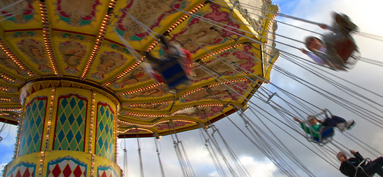 happy swing carnival ride with vibrant canopy and riders enjoying a classic amusement park attraction