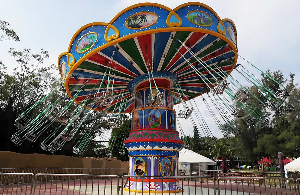 Hurricane swing carnival ride combining rotation, lift, and swinging motion for adrenaline-seeking riders
