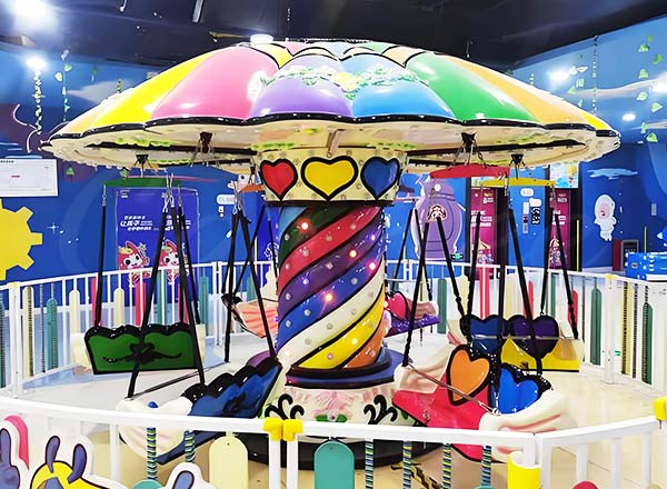  Colorful rainbow-themed family swing chair ride with bright lights and playful designs, ideal for children and families.