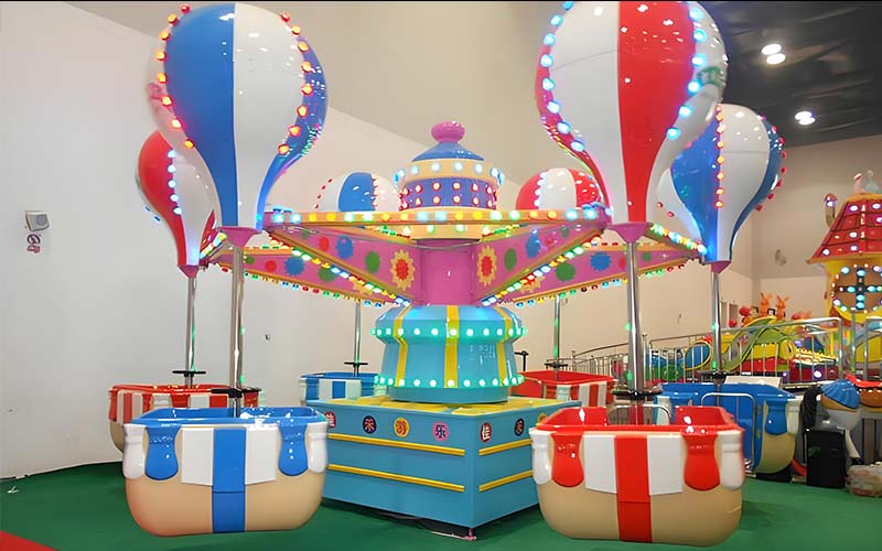 Indoor Samba Balloon Ride installation with colorful cabins and LED lights in a children’s playground