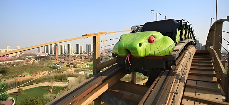 Snake-themed backyard roller coaster car climbing wooden track with city skyline in background