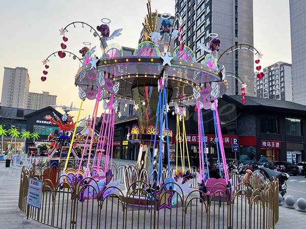 Themed wave swinger ride with colorful canopy and chain swings, offering a unique customized design for amusement and carnival parks.