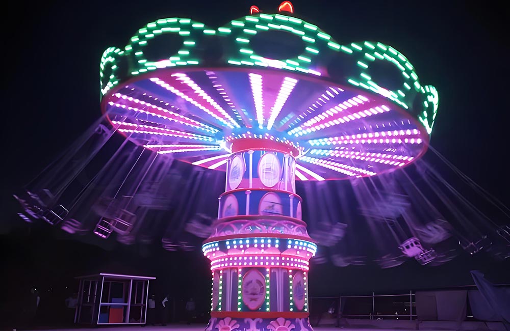 Wave swinger ride with tilting canopy, a family-friendly swing carousel with gentle wave-like motion