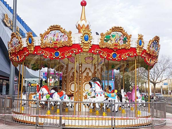 Completed installation of a 16-seater outdoor carousel ride featuring colorful horses and luxury decorative panels.