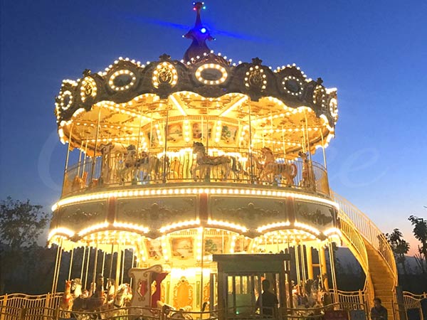 48 Seats Double Decker Swing Carousel Ride illuminated at night, showcasing its vibrant lights and design