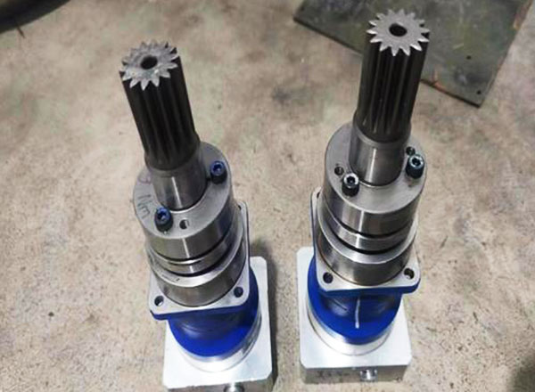 Close-up of metal gears and a motor, essential components for carousel drive system