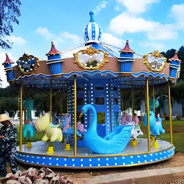 Colorful small kiddie carnival carousel ride with a variety of animal figures like swans, pigs, and more for a joyful ride experience.