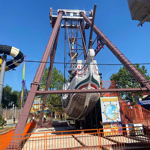 The custom-designed Pirate Ship amusement ride by Carnee Rides featuring unique pirate-themed graphics, installed at a public park in Russia.