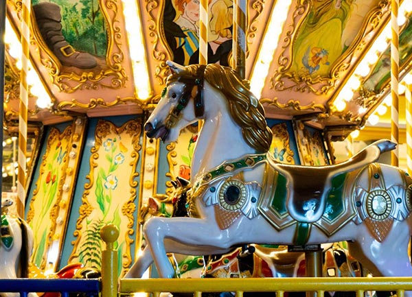 Close-up of carousel horse on a luxury double decker merry go round in a UAE shopping mall, showcasing detailed fiberglass craftsmanship and premium carousel rides for sale.