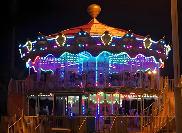 Colorful double-decker carousel for sale, designed for amusement parks with multi-level seating and a fun, whimsical theme