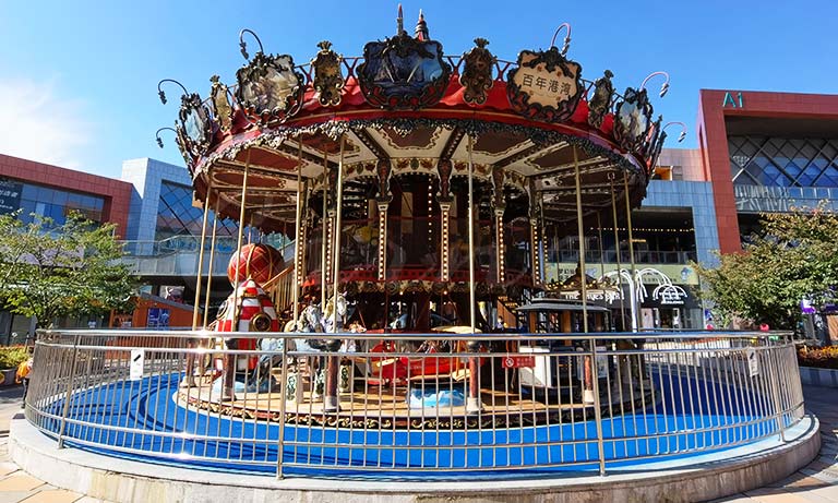 Installed double-decker carousel ride by Carnee Rides in a commercial plaza, showcasing CE and ISO-certified amusement ride quality and safety compliance