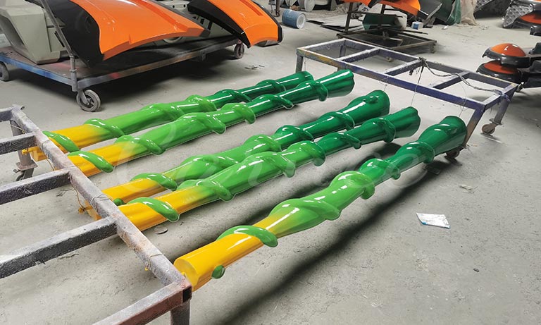 Automotive-grade baking paint process for Carnee Rides double-decker carousel ride components, showing multi-layer coating and glossy surface treatment.